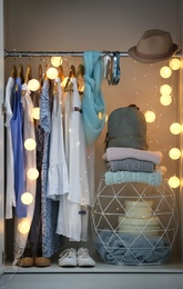 Photo of Women clothing on hangers in wardrobe