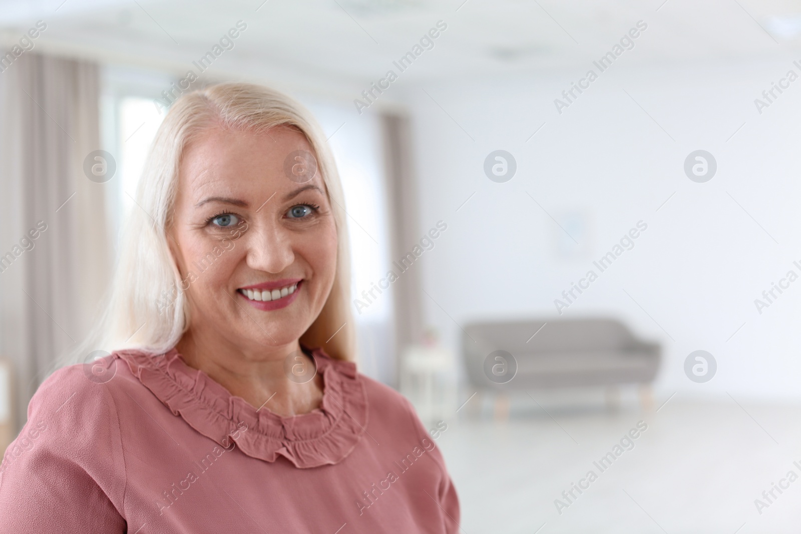 Photo of Portrait of beautiful older woman against blurred background with space for text