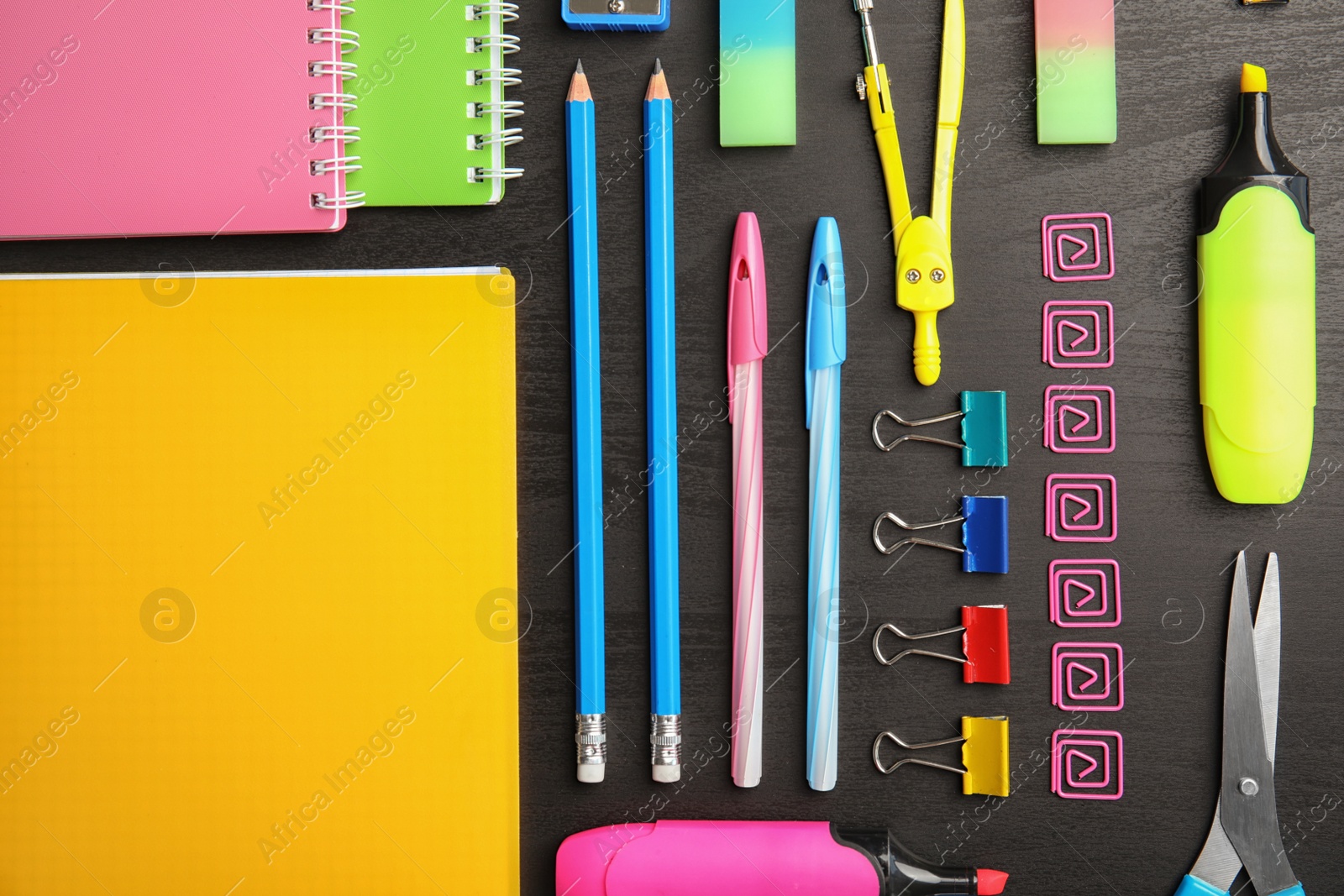 Photo of Different school stationery on wooden background, flat lay