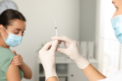 Photo of Doctor giving injection to patient in hospital, closeup. Vaccination day