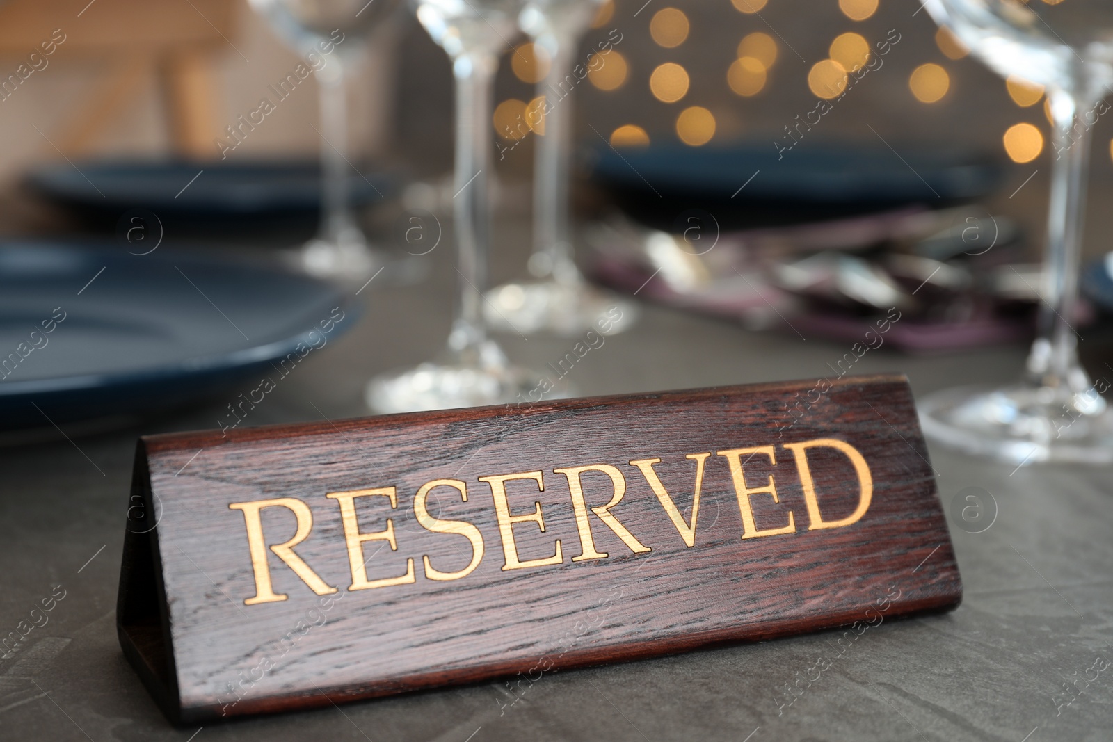 Photo of Table setting with RESERVED sign in restaurant