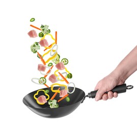 Image of Man tossing ingredients in wok on white background, closeup