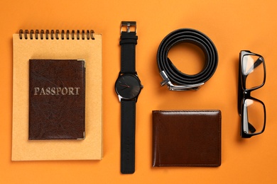 Photo of Flat lay composition with male accessories, passport and notebook on colorful background