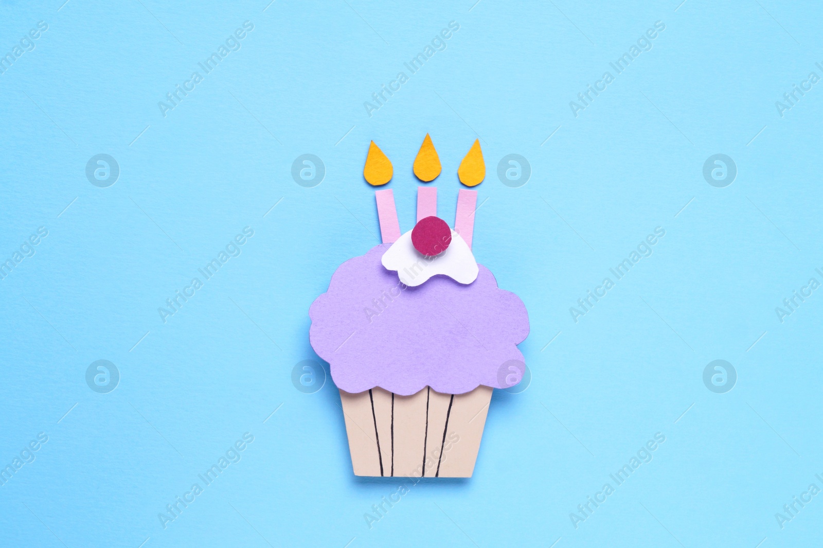 Photo of Birthday party. Paper cupcake on light blue background, top view
