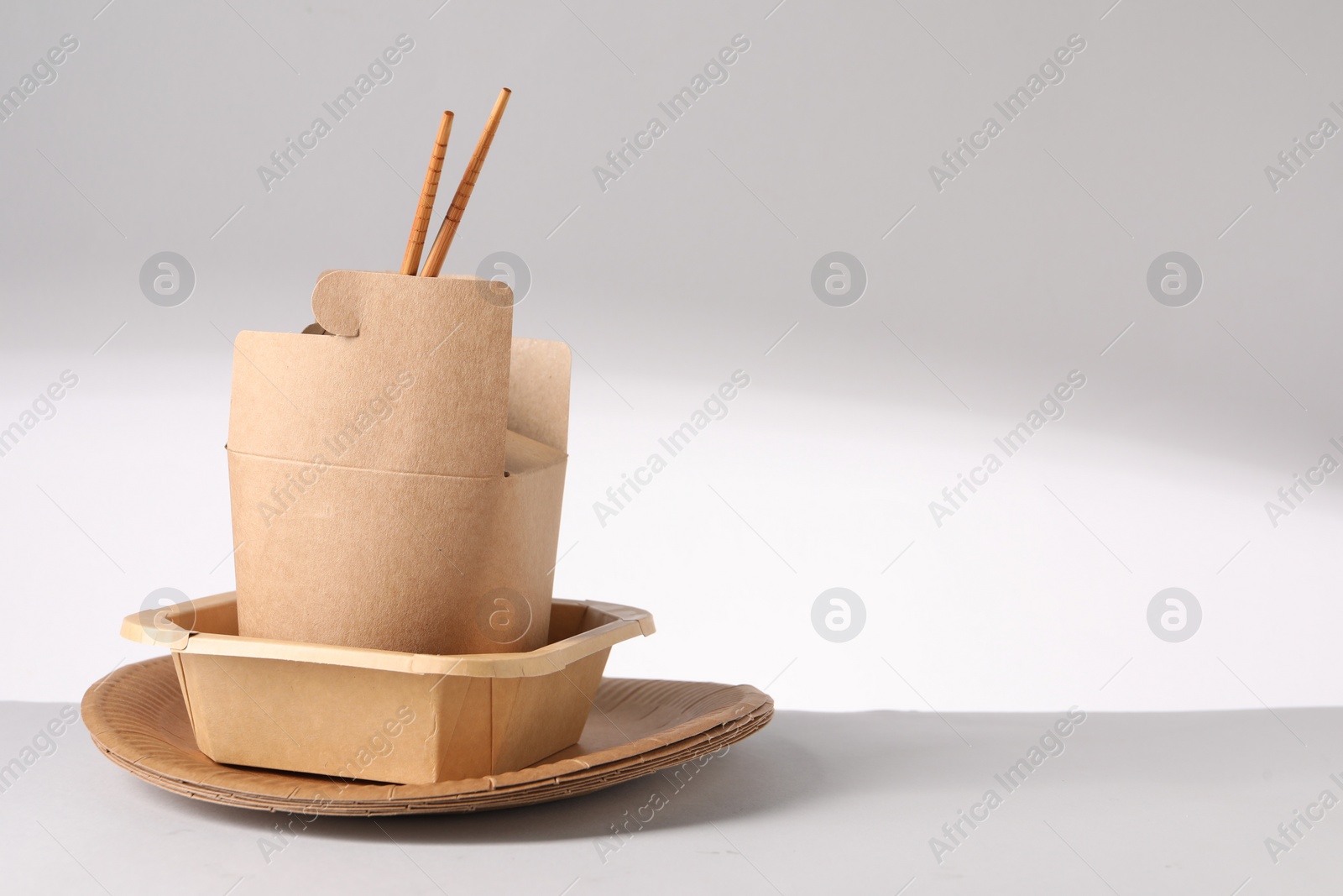 Photo of Eco friendly food packagings on light background. Space for text