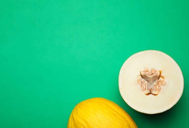 Photo of Ripe tasty melons on green background, flat lay. Space for text