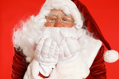 Happy authentic Santa Claus on red background