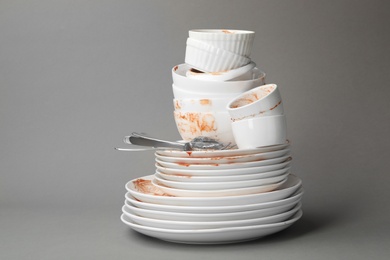 Photo of Set of dirty dishes on grey background