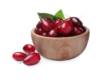 Photo of Fresh ripe dogwood berries with green leaves in wooden bowl on white background