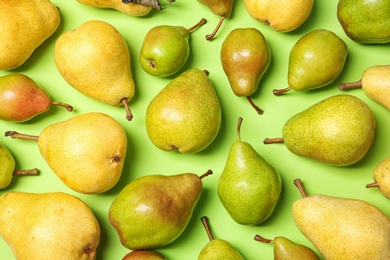 Flat lay composition with fresh ripe pears on color background