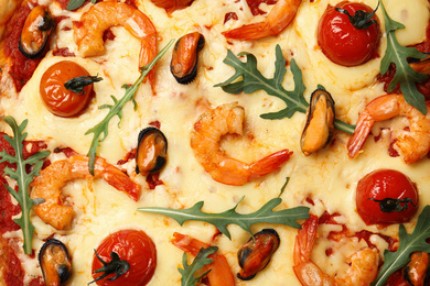 Delicious seafood pizza as background, top view