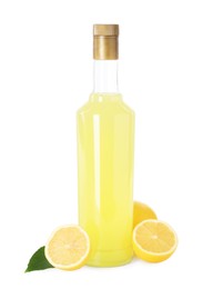 Photo of Bottle of tasty limoncello liqueur, lemons and green leaf isolated on white