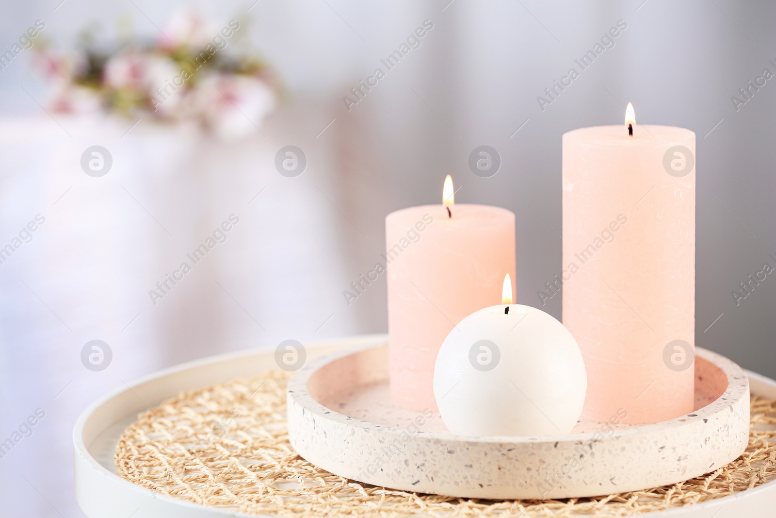 Photo of Burning candles on table indoors. Space for text