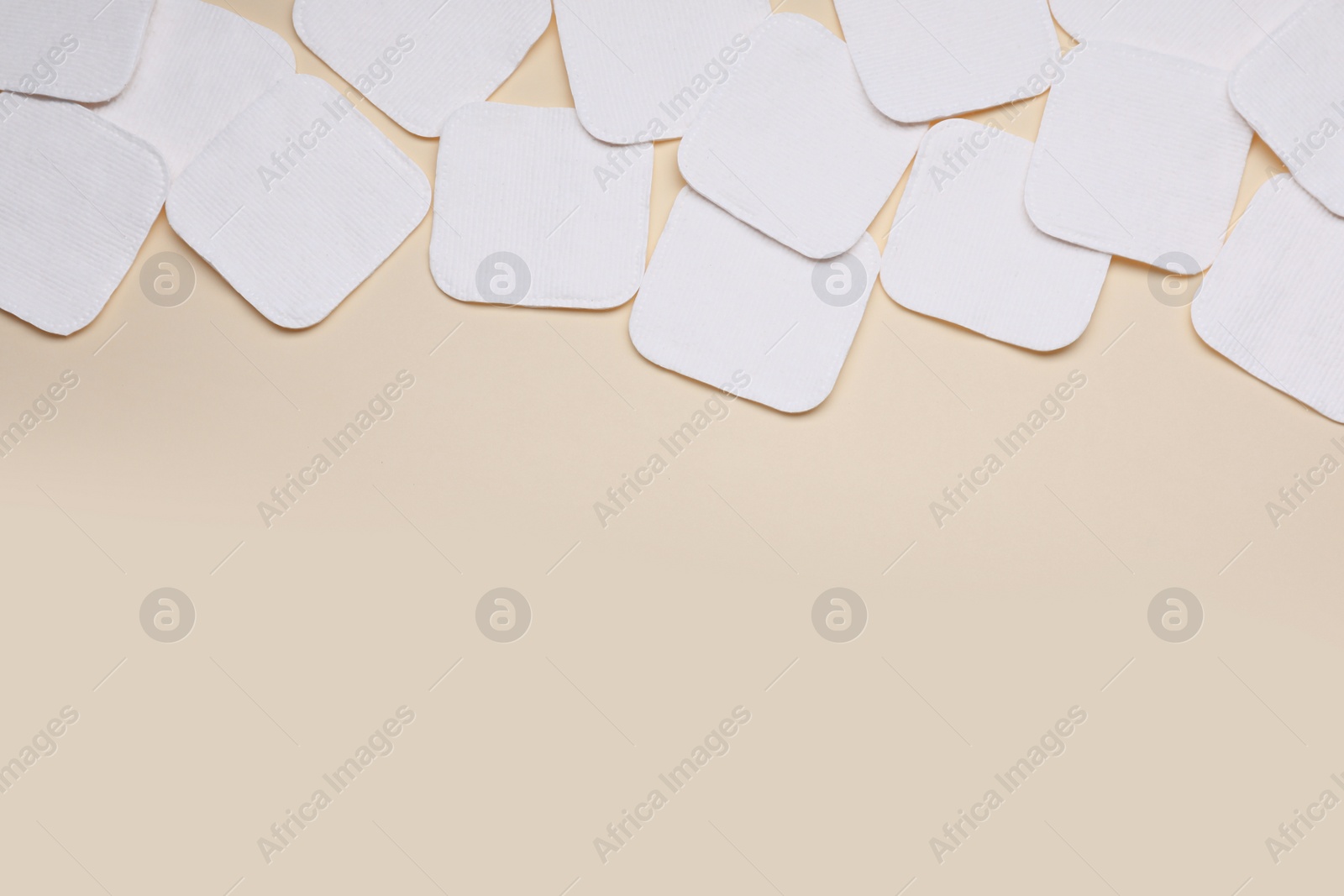 Photo of Many clean cotton pads on yellow background, flat lay. Space for text