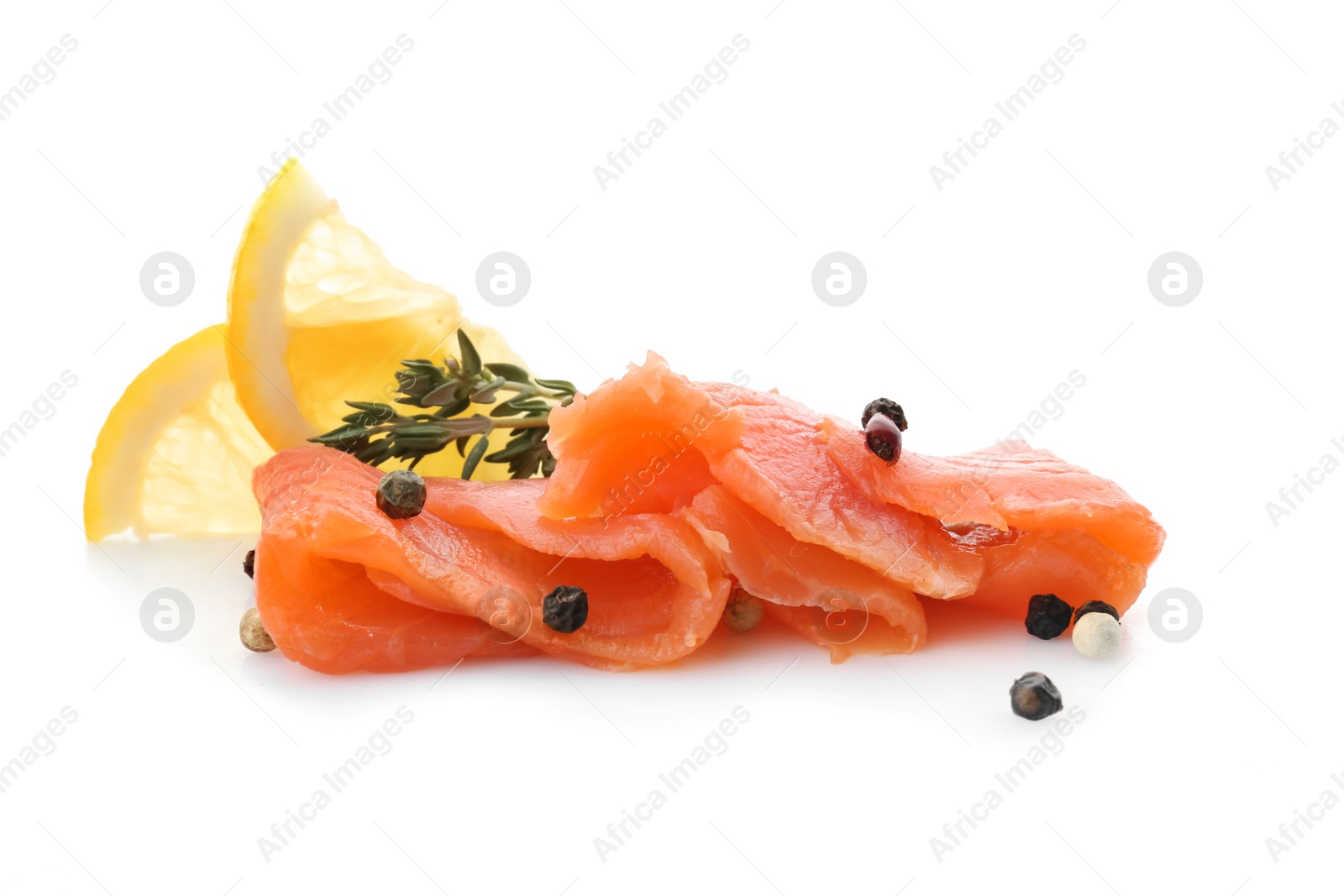 Photo of Fresh sliced salmon fillet with thyme and lemon on white background