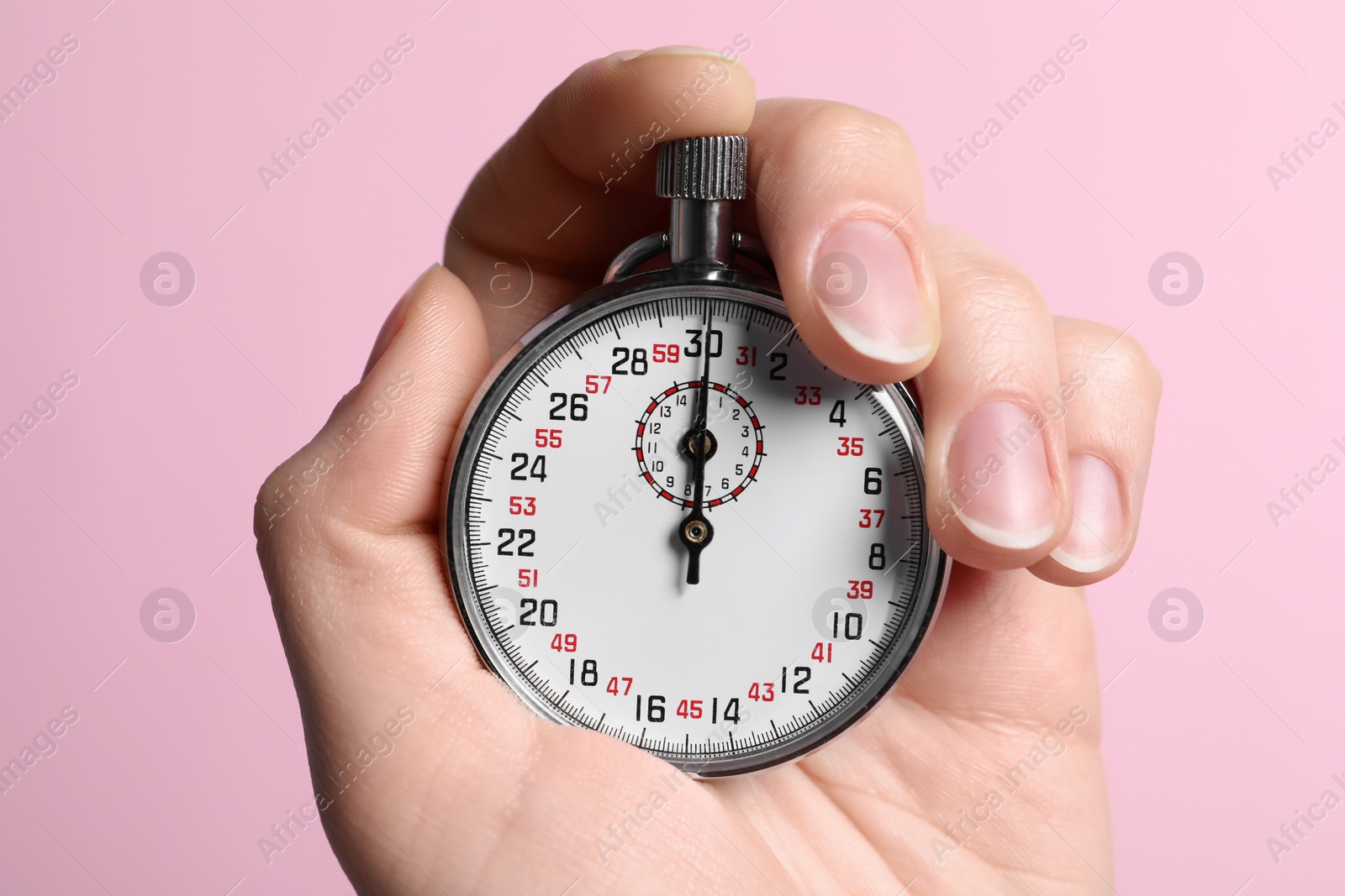 Photo of Woman holding vintage timer on pink background, closeup