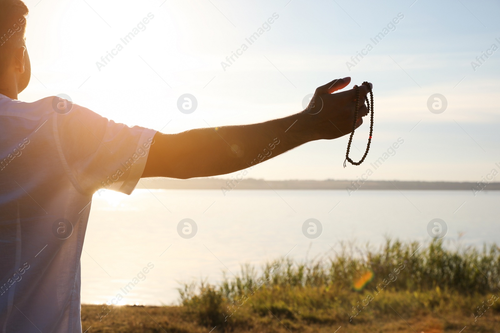 Photo of Man near river at sunset, closeup. Nature healing power