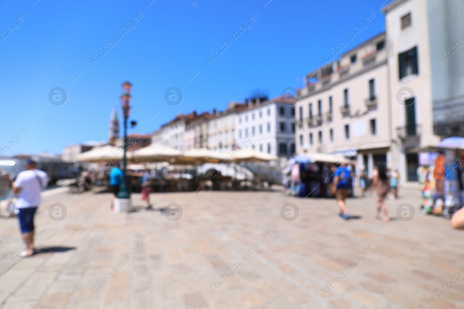 Photo of VENICE, ITALY - JUNE 13, 2019: Blurred view of city street with cozy cafe