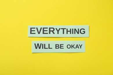 Cards with phrase Everything Will Be Okay on yellow background, flat lay