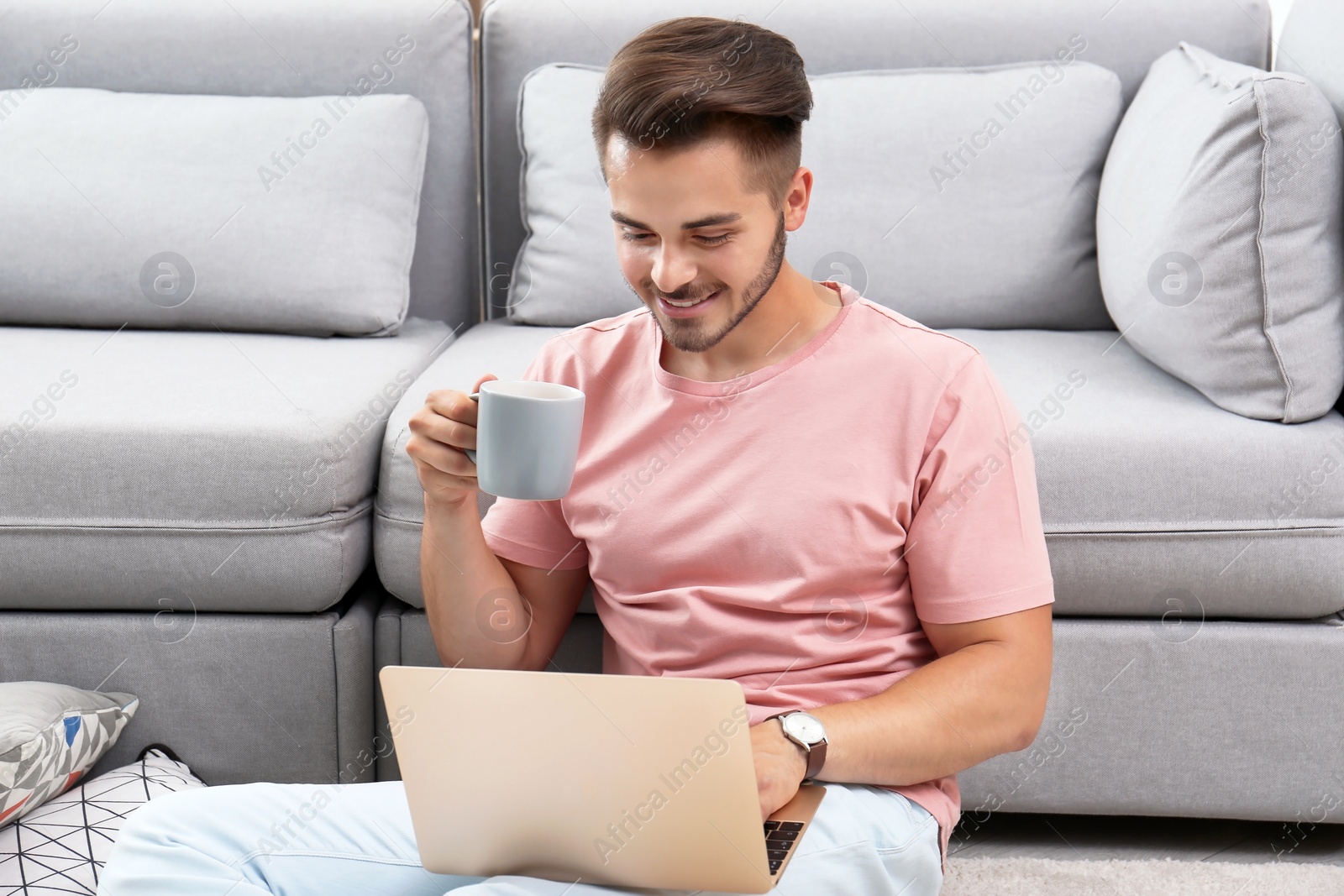 Photo of Man in casual clothes using laptop at home