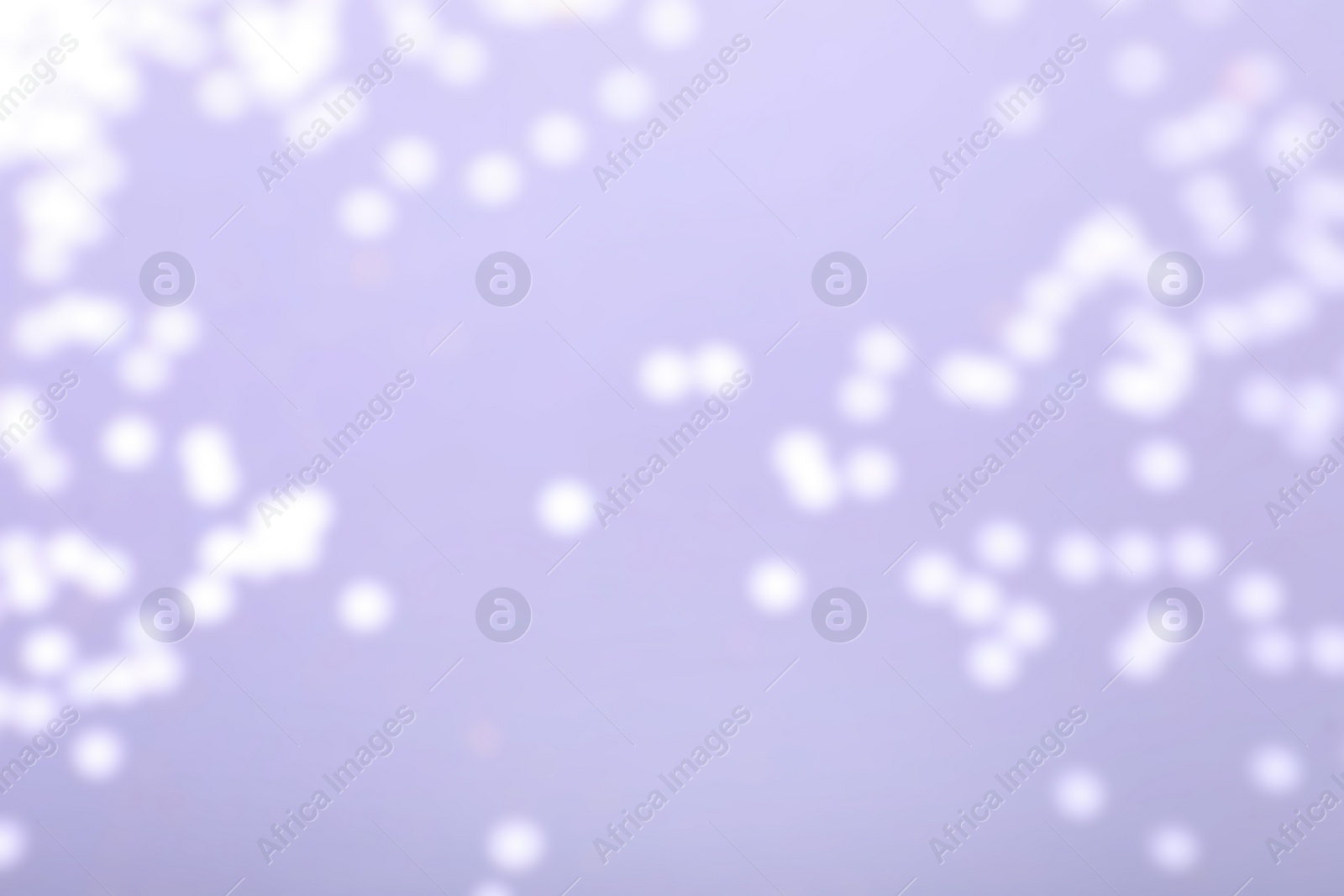 Photo of Blurred view of festive lights on light background. Bokeh effect