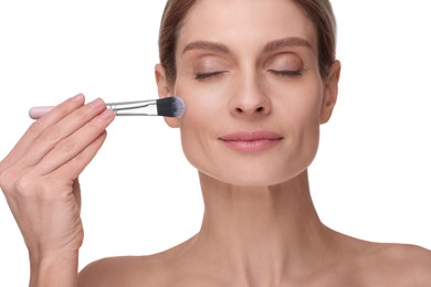 Woman with makeup brush on white background