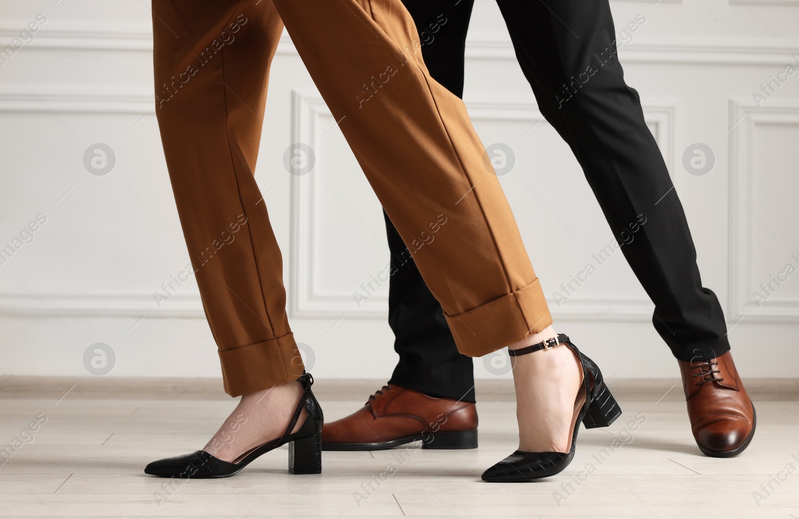 Photo of Businessman and businesswoman in elegant shoes indoors, closeup