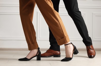 Businessman and businesswoman in elegant shoes indoors, closeup