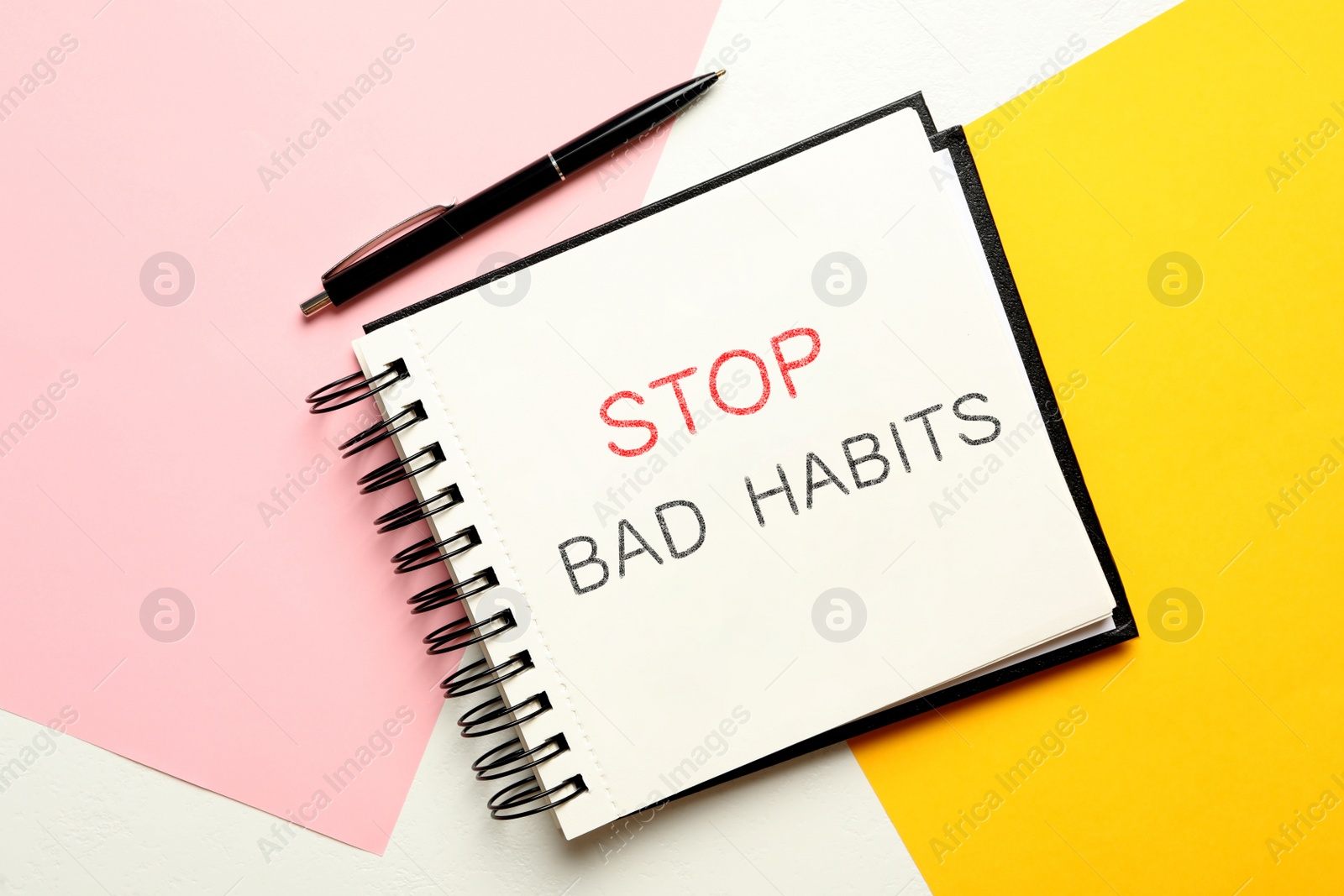 Image of Notebook with phrase Stop Bad Habits and pen on color background, flat lay