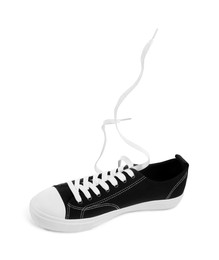 Photo of One black classic old school sneaker isolated on white