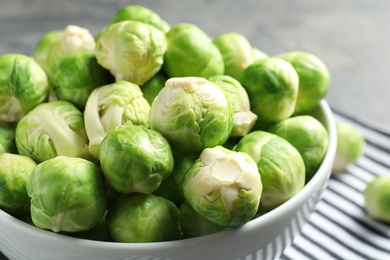 Photo of Bowl of fresh Brussels sprouts on table, closeup