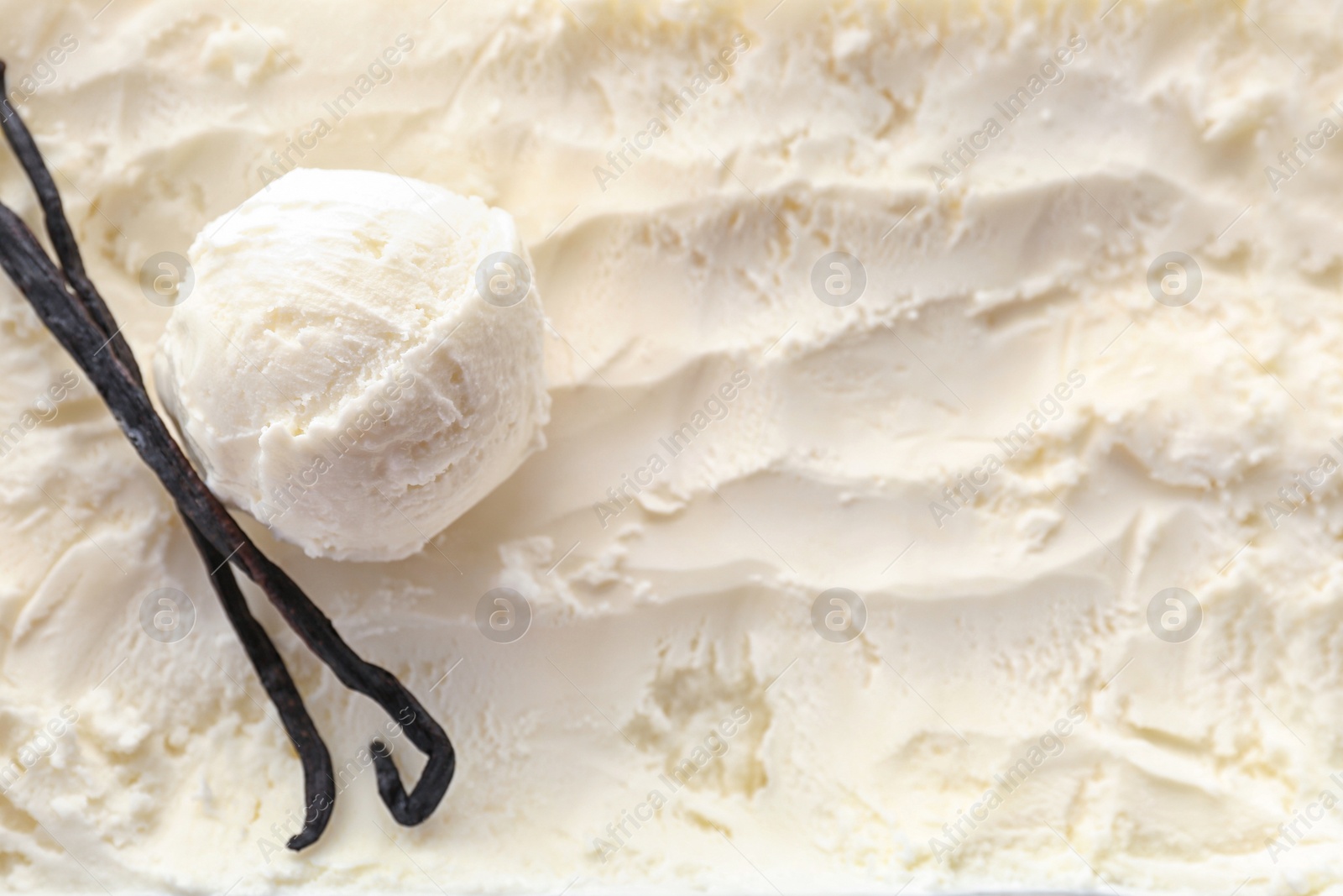 Photo of Tasty vanilla ice cream and sticks, closeup