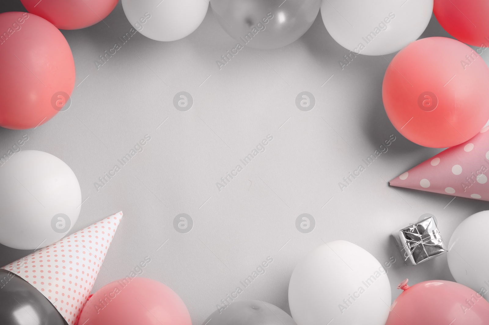 Photo of Flat lay composition with air balloons and space for text on white background