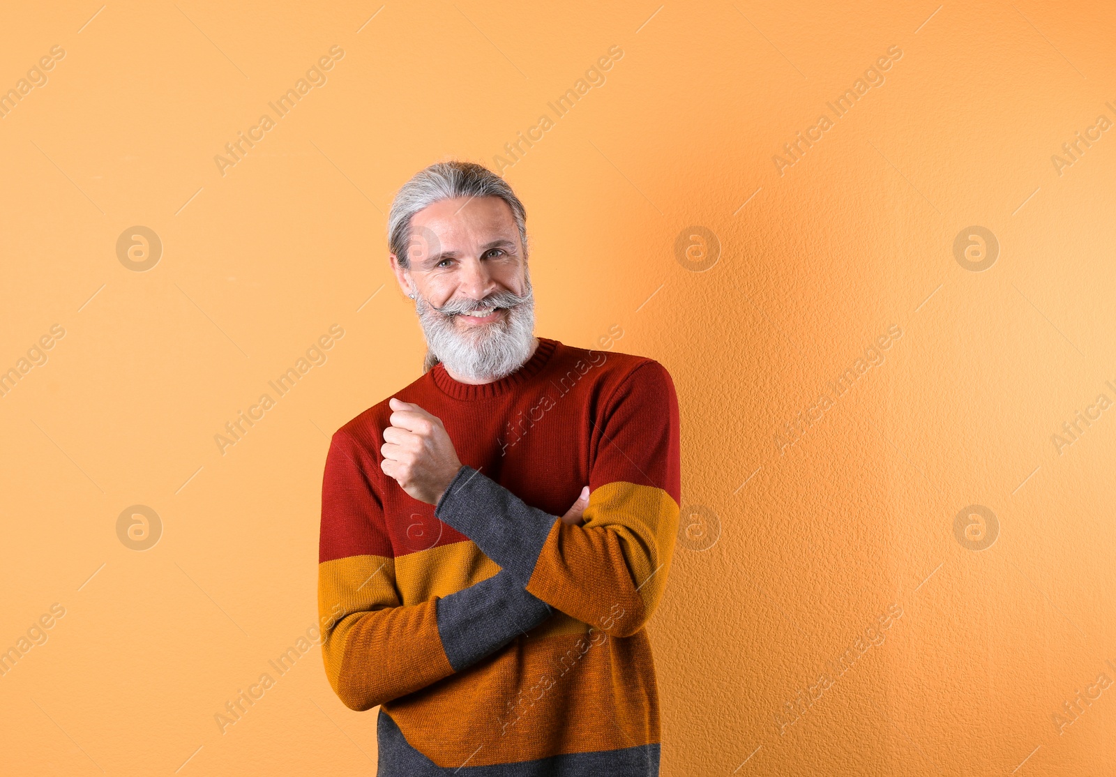 Photo of Portrait of handsome mature man on color background