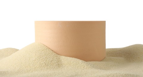 Photo of Presentation of product. Beige podium on sand against white background