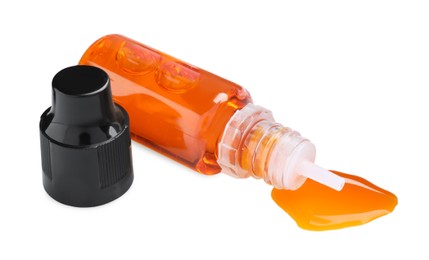 Photo of Bottle of orange food coloring on white background
