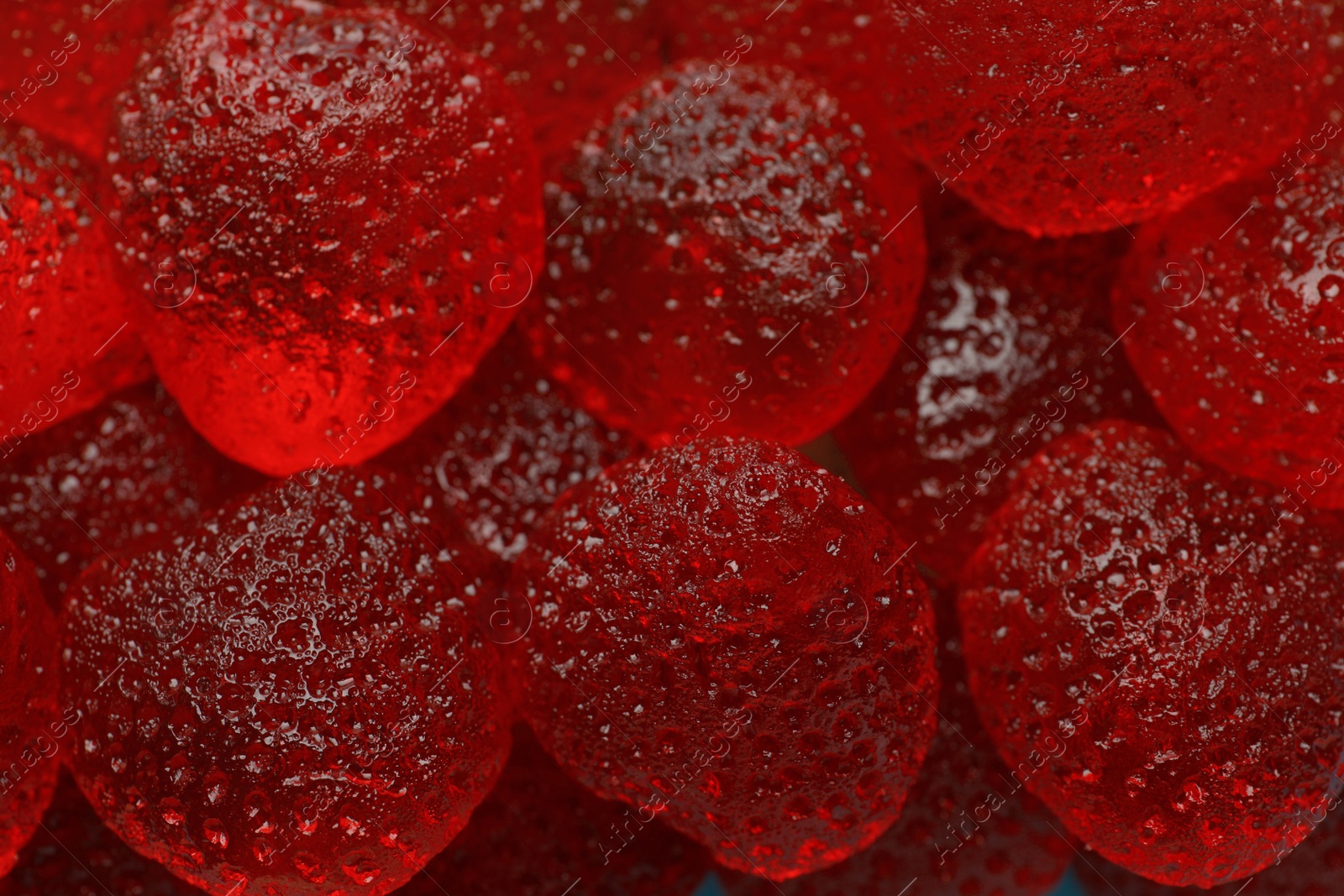 Photo of Delicious gummy strawberry candies as background, closeup