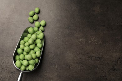 Photo of Tasty wasabi coated peanuts on grey table, flat lay. Space for text