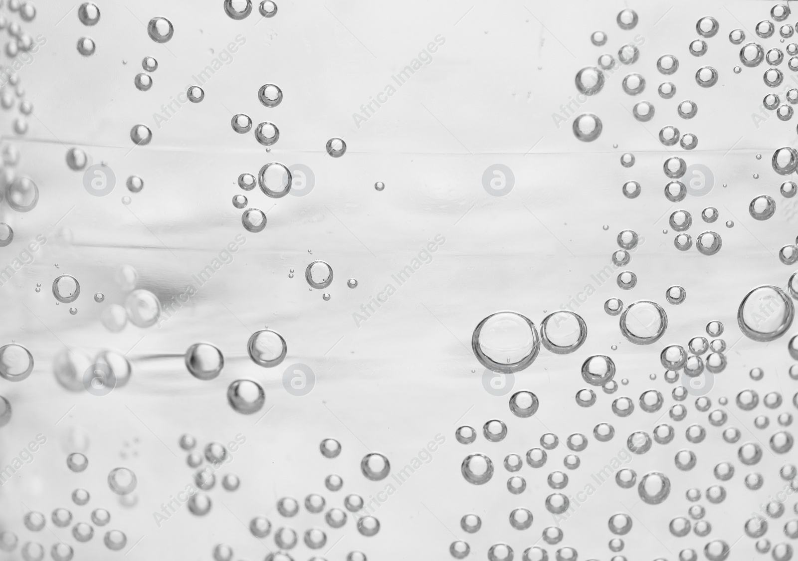 Photo of Soda water with bubbles of gas, closeup