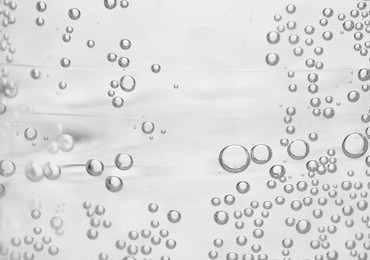 Photo of Soda water with bubbles of gas, closeup