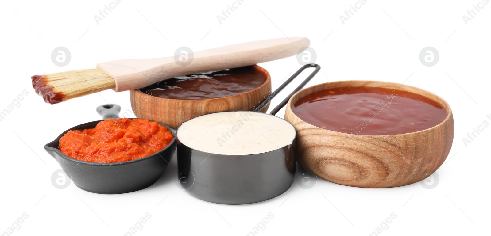 Photo of Different marinades and basting brush isolated on white