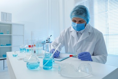 Photo of Scientist working at table in laboratory. Medical research