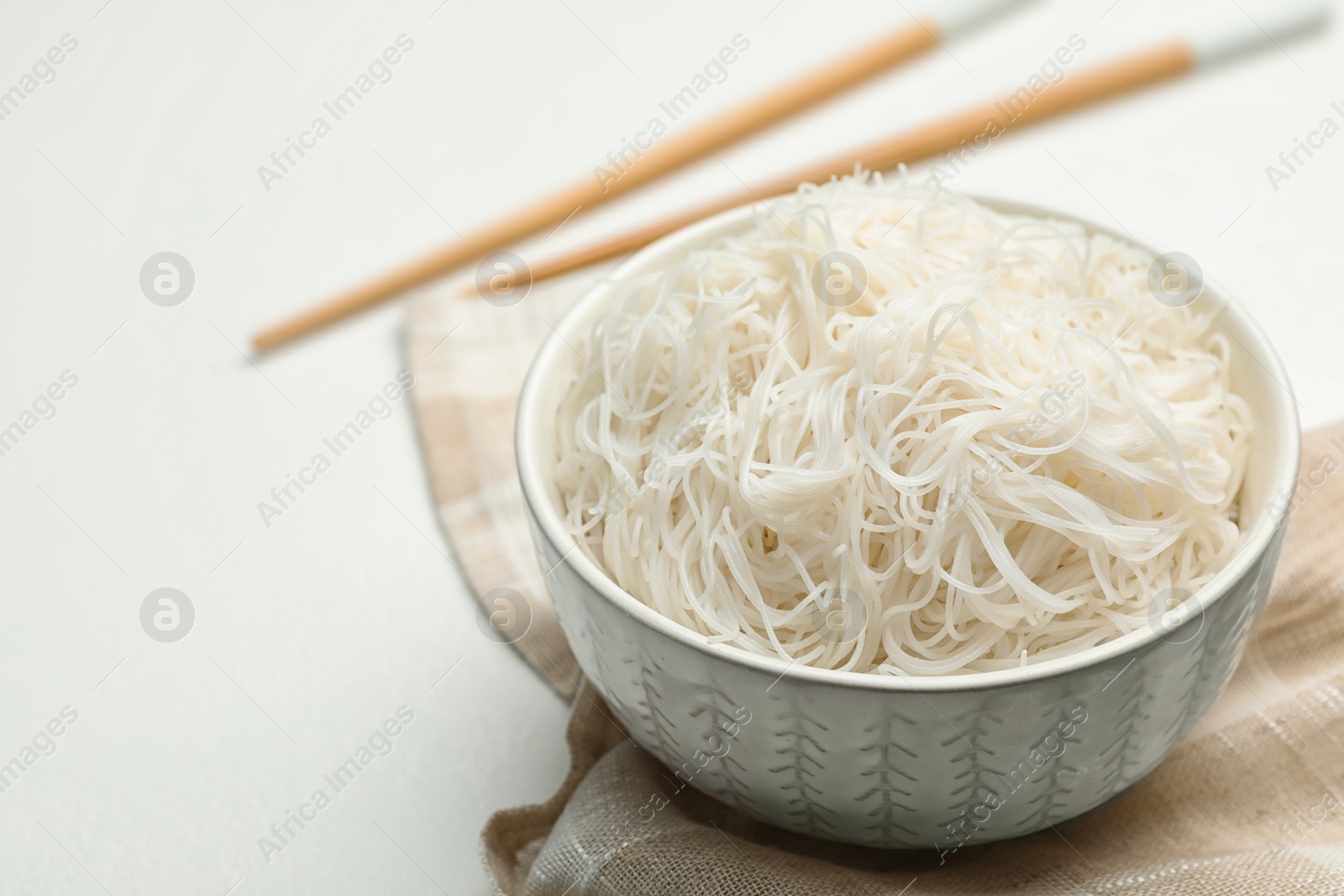Photo of Tasty cooked rice noodles on white table