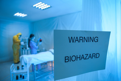 Photo of Sign with words WARNING BIOHAZARD near quarantine ward. Virus awareness