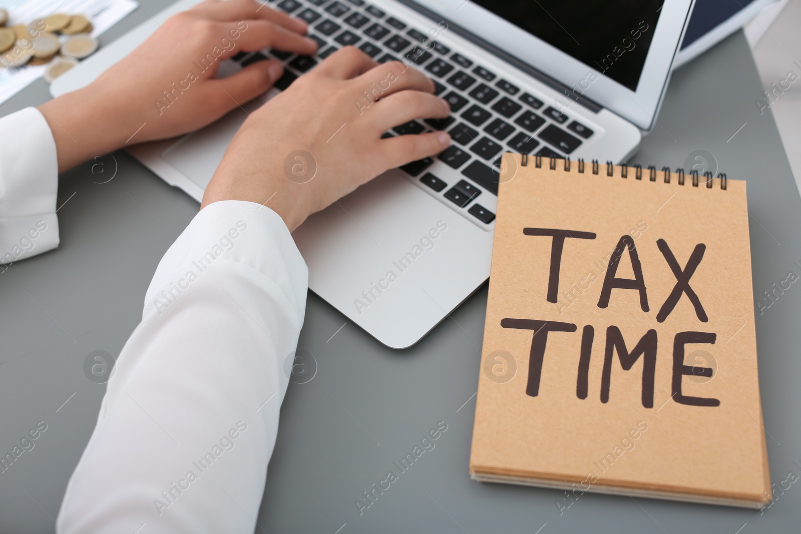 Photo of Young female calculating taxes at table, closeup