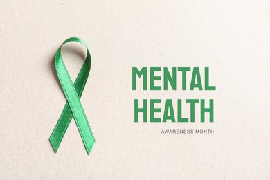 World Mental Health Day. Green ribbon on white background, top view