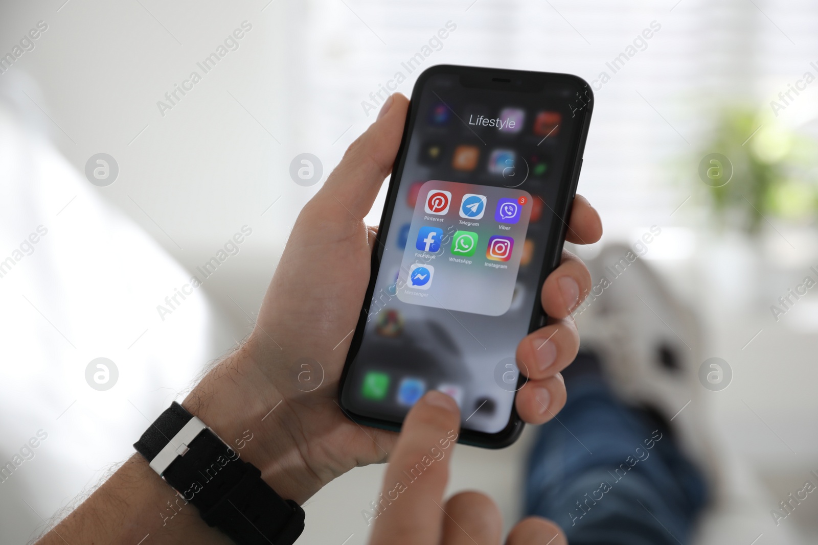 Photo of MYKOLAIV, UKRAINE - MARCH 16, 2020: Man holding iPhone 11 with social media icons on screen indoors, closeup