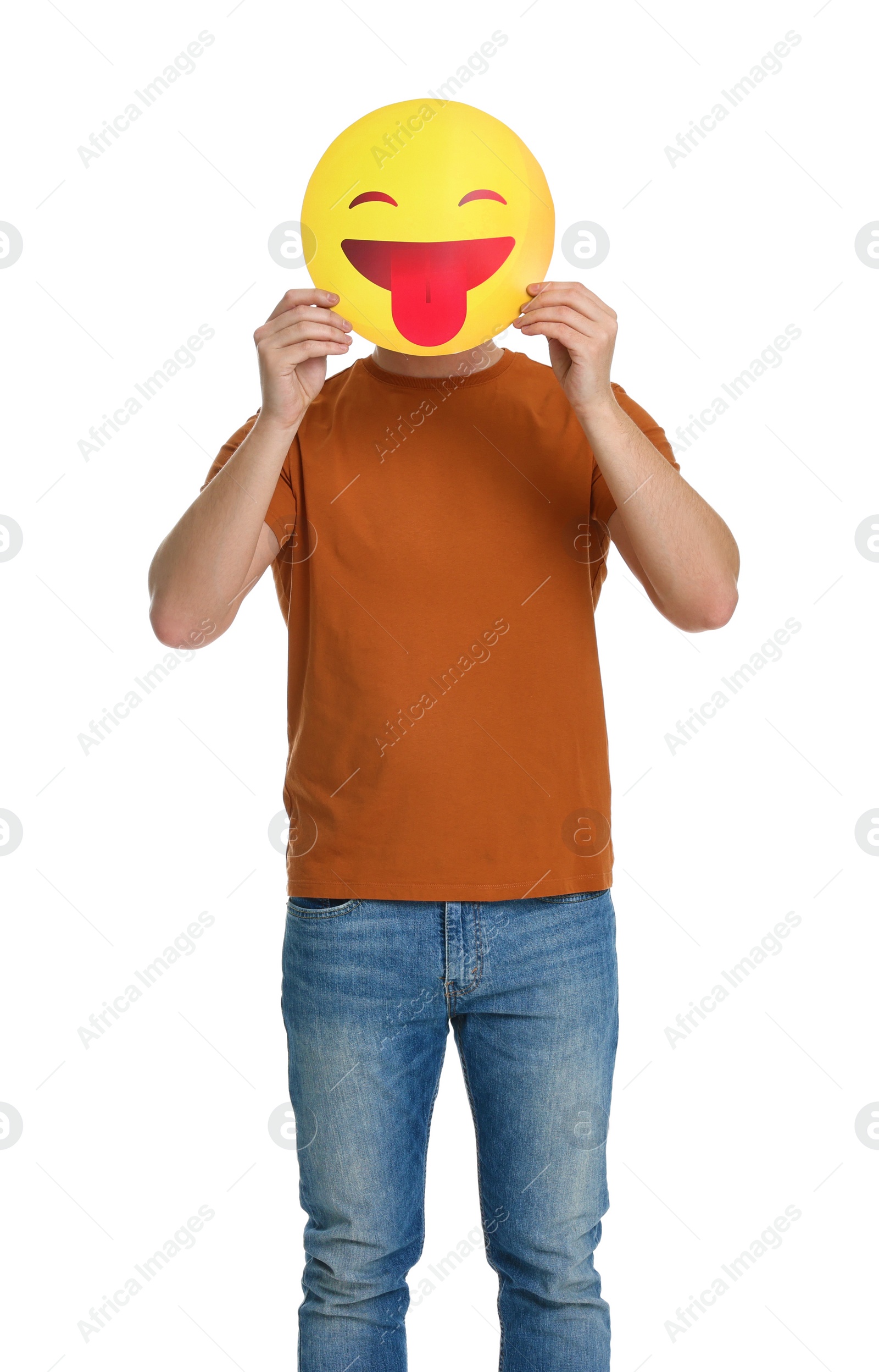 Photo of Man covering face with emoticon sticking out tongue on white background