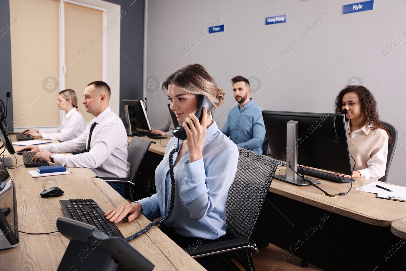 Photo of Call center operators working in modern office