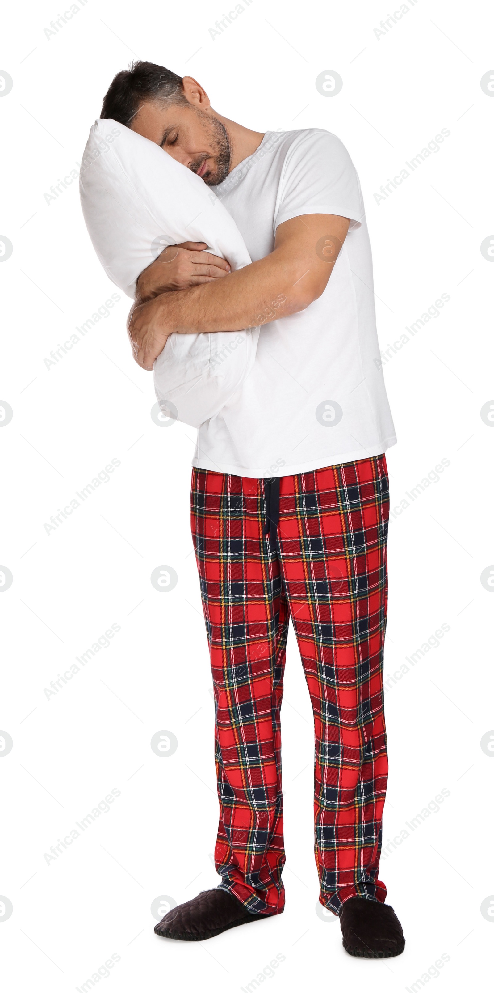 Photo of Man hugging pillow in sleepwalking state on white background